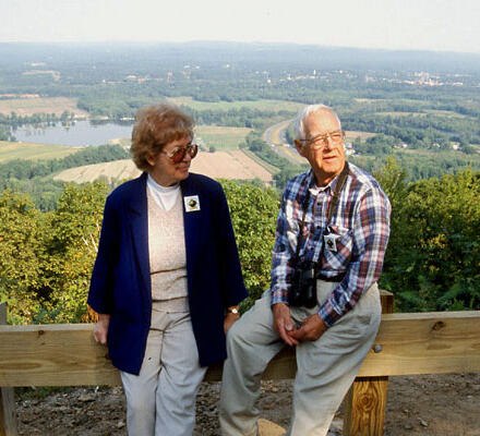 Visitors looking out from a rocky viewpoint at Mount Tom State Reservation.