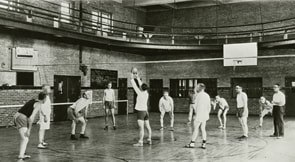 An archival photograph of an early volleyball game, shared by the International Volleyball Hall of Fame.